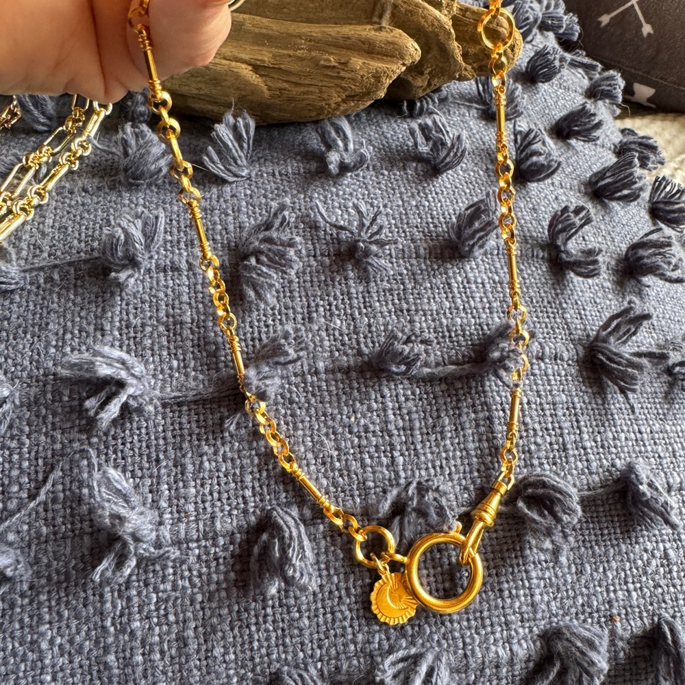 Unique gold plate necklace with multiple links, charm and unique closure. 18 in